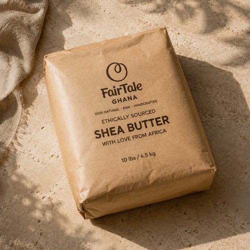 A 10 lb kraft paper bag of FairTale Ghana Shea Butter, photographed on a textured stone surface with natural dappled sunlight and shadows.
