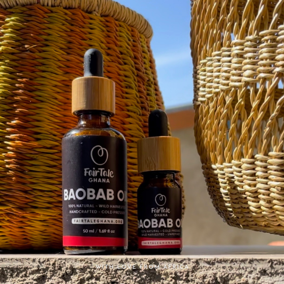 Two sizes of FairTale GHANA Baobab oil bottles standing against woven baskets outdoors