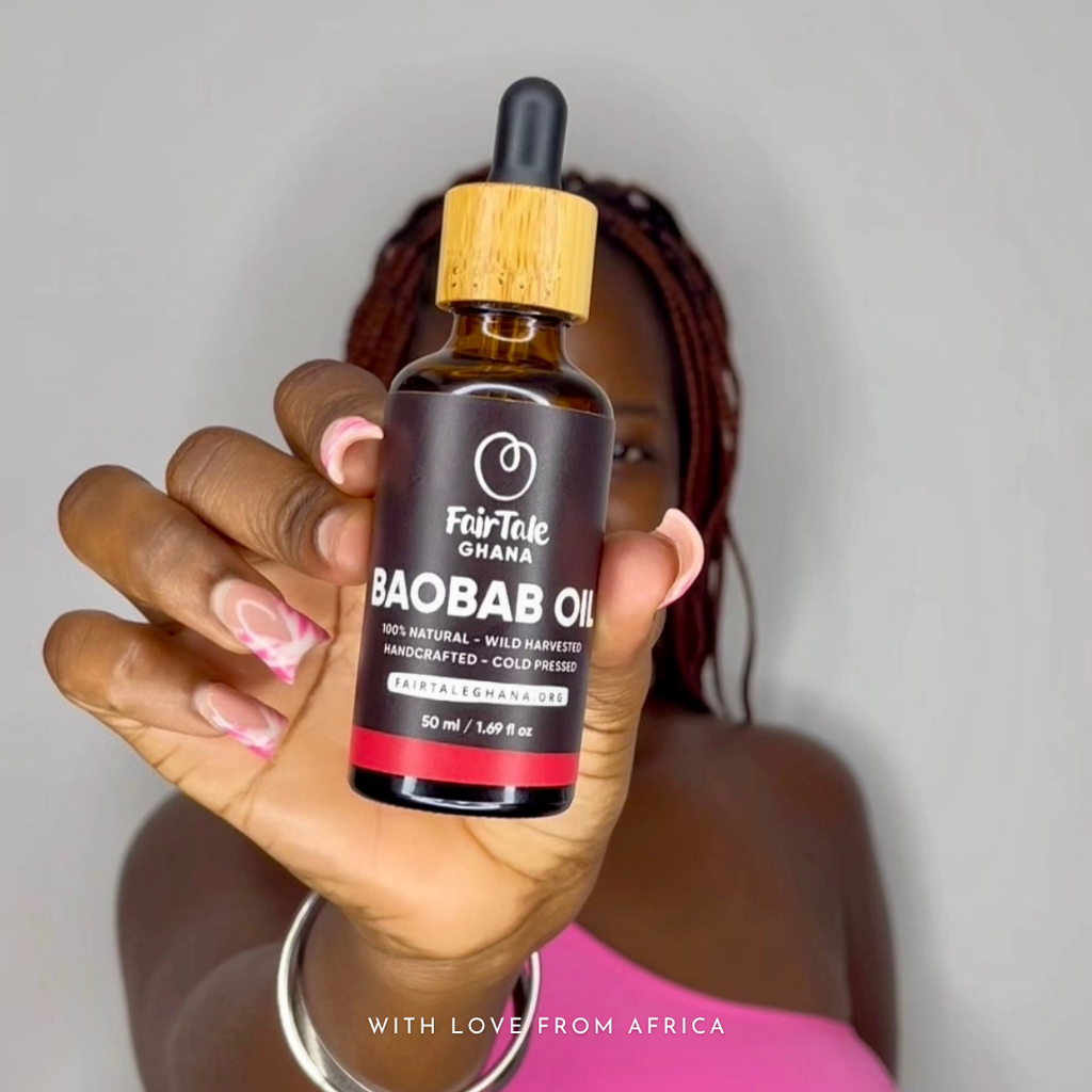 Woman holding up a FairTale GHANA Baobab oil bottle to the camera